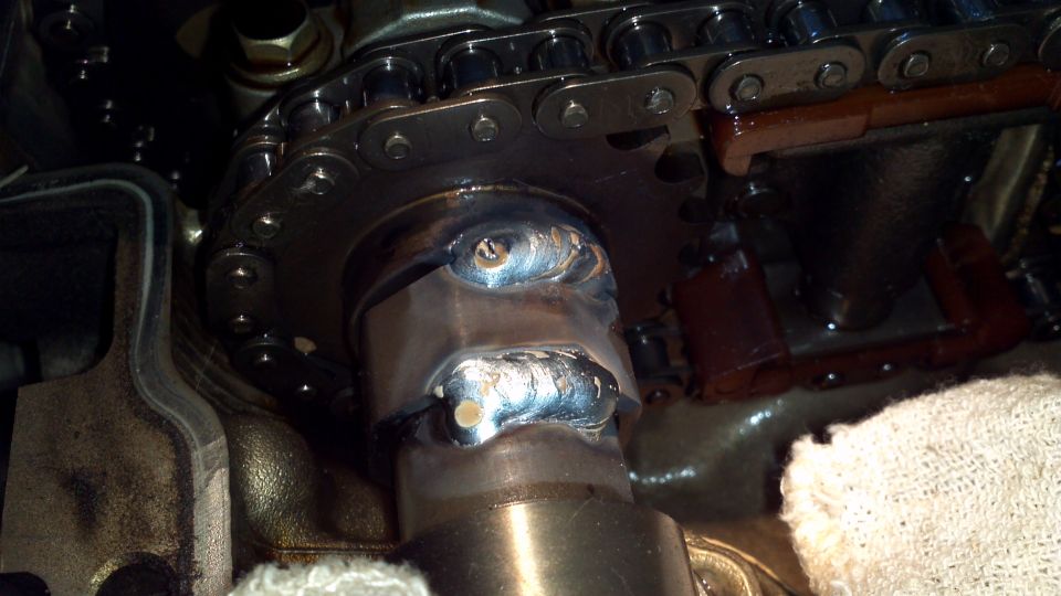 Engine part with timing chain and visible welds. Supermotors.net watermark present