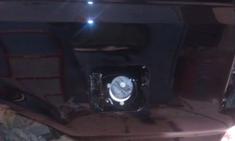1995 Ford Bronco - Close-up of a vehicle's fuel door, showing the cap mechanism inside.