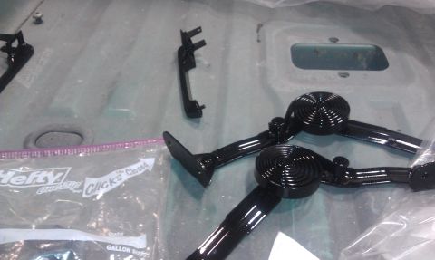 1995 Ford Bronco - New black door handles and interior trim parts are laid out next to a plastic bag.