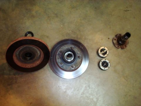 1995 Ford Bronco - Vehicle brake components, including rotors and hub assemblies, are displayed on a floor.