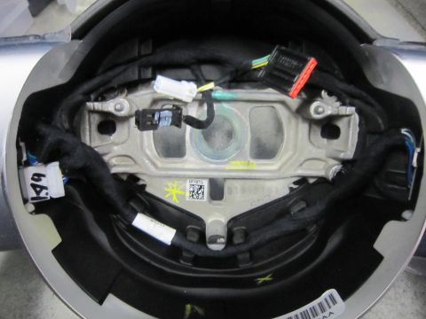 2008 Jeep Wrangler - Close-up of a steering wheel airbag module, showing internal wiring and connectors.