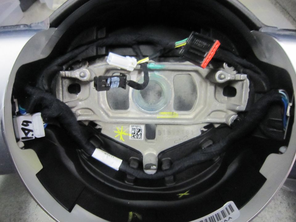 Steering wheel airbag module with wiring harnesses and connectors visible