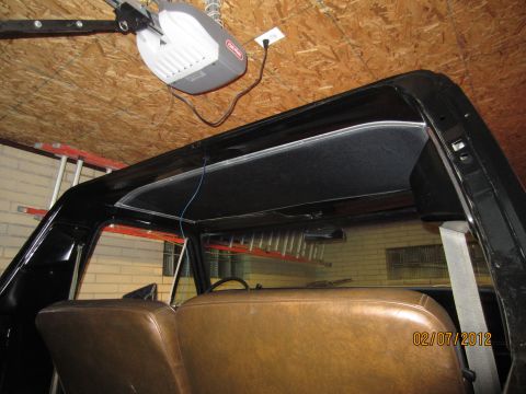 1979 Ford Bronco - Interior view of a 1979 Ford Bronco, showing seats and headliner. Garage door opener is mounted overhead.