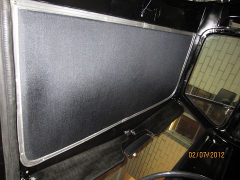 1979 Ford Bronco - This photo shows the interior of a vehicle, focusing on the door panel and window trim with a textured black finish.