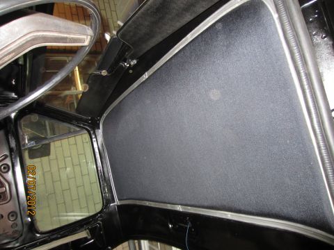 1979 Ford Bronco - Interior view of a black vehicle, likely a 1979 Ford Bronco, showing the A-pillar, dashboard, and part of the steering wheel. The driver's…