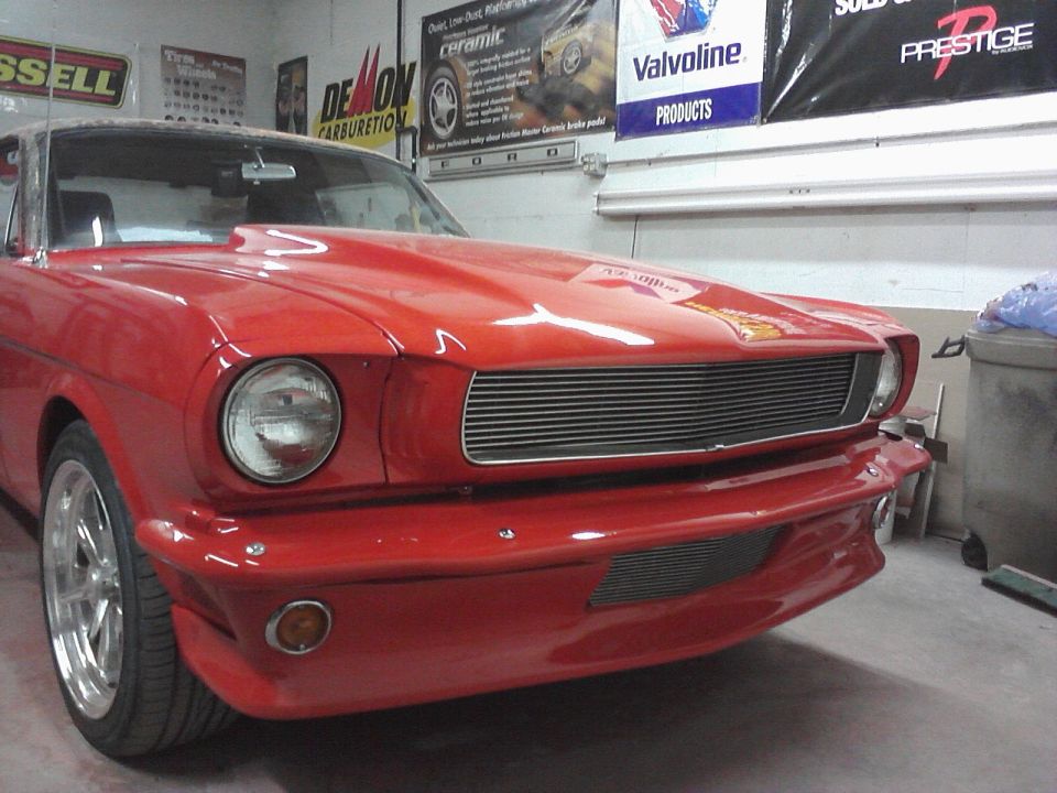 Red 1966 Ford Mustang front view with custom hood scoop and grille