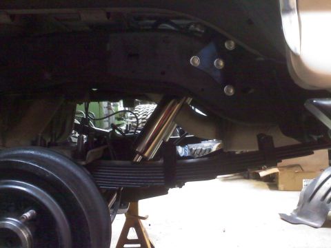 1996 Ford Bronco - Vehicle undercarriage with suspension components visible, possibly undergoing modification.