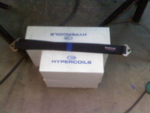 1996 Ford Bronco - A suspension brace rests on boxes labeled HYPERCOILS, suggesting automotive parts.