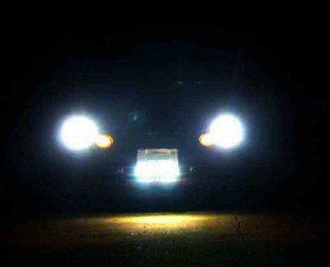 1997 Ford Taurus - The front of a vehicle is visible at night, with its headlights and grille illuminated.