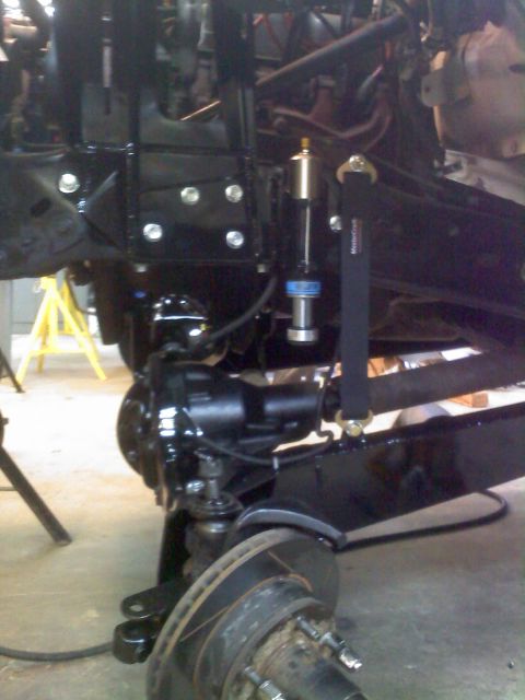 1996 Ford Bronco - Close-up view of vehicle suspension and brake components during a build.