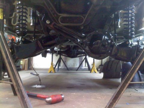 1996 Ford Bronco - Undercarriage view of a 1996 Ford Bronco during suspension work.
