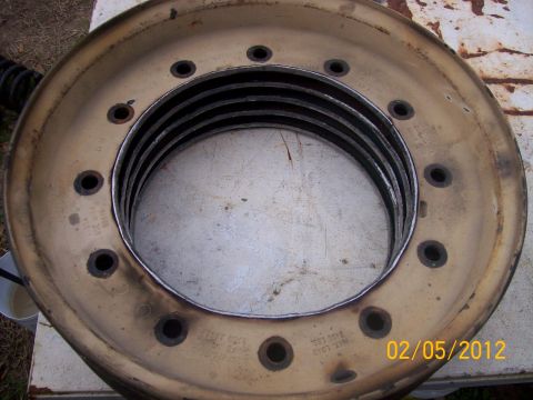 1982 Ford F-100 - A close-up view of a worn truck wheel rim, showing its construction and a date stamp.