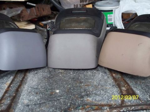 1993 Ford Bronco - Three vehicle interior console pieces are displayed on a textured surface, with a date stamp and website visible.