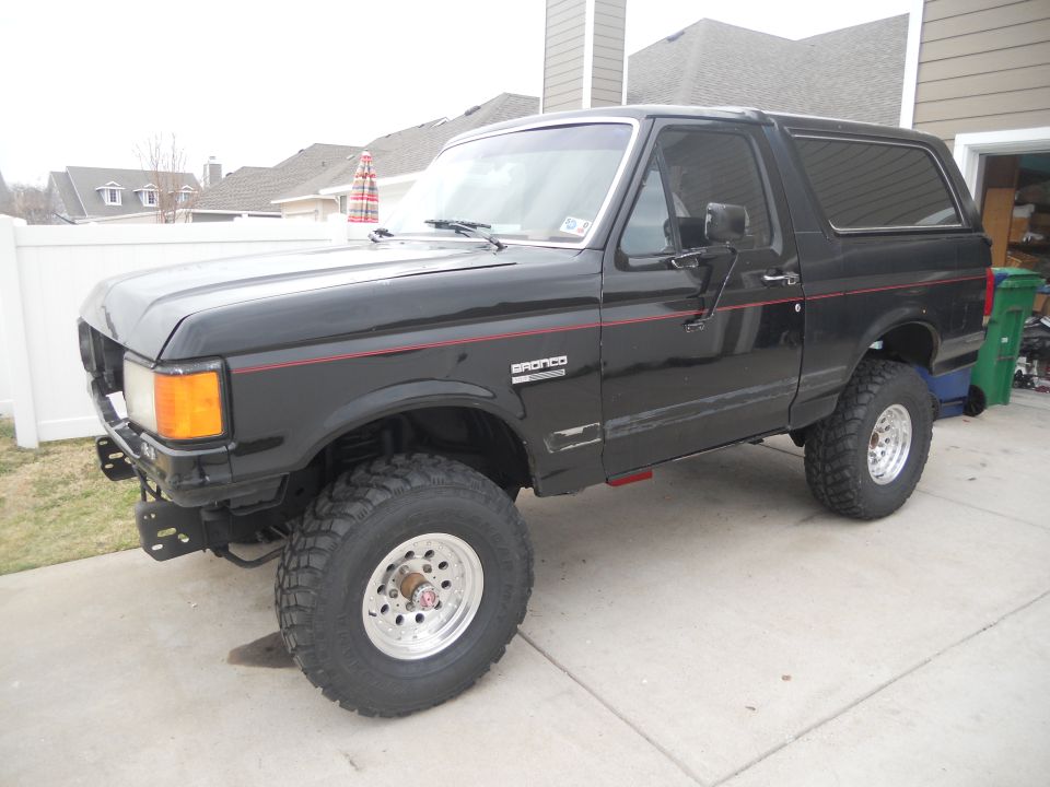 Black 1991 Ford Bronco, 3/4 front view, lifted with aftermarket wheels