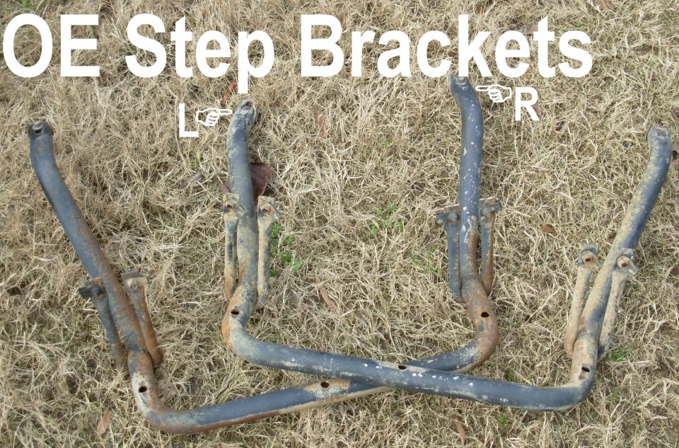 Pair of rusty OE step brackets laid on grass labeled left and right