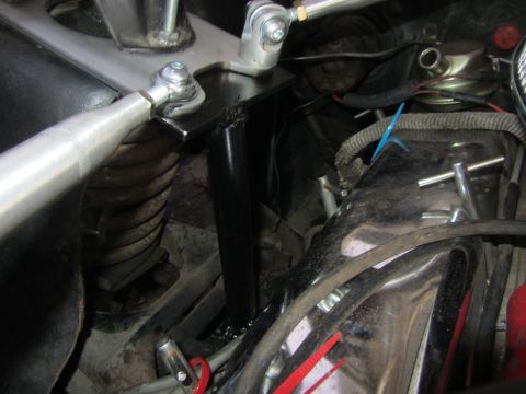 1964 Ford Ranchero - Close-up view of the engine bay bracing on a 1964 Ford Ranchero, showing adjustable rods and a black support structure.