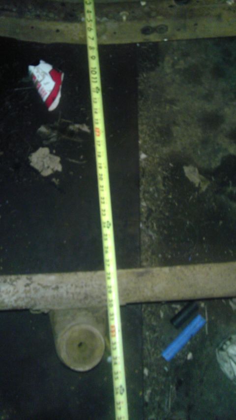 1987 Ford Ranger - A measuring tape is laid out over a cluttered surface with debris and a white cylindrical object.