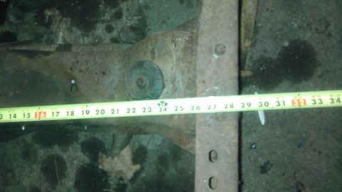 1987 Ford Ranger - A close-up of a vehicle's front suspension component is shown with a measuring tape indicating measurements from 13 to 34 inches.