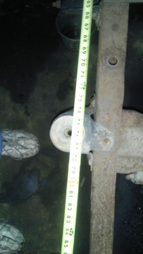 1987 Ford Ranger - A measuring tape is shown against a rusty truck suspension component.
