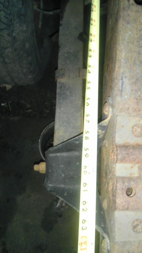 1987 Ford Ranger - Close-up of a vehicle's leaf spring and suspension bracket, with a tape measure for scale.