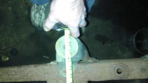 1987 Ford Ranger - Measuring a suspension bushing on a vehicle frame.