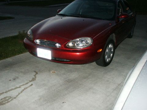 1998 Mercury Sable - Front view of a red 1998 Mercury Sable parked on a concrete driveway.
