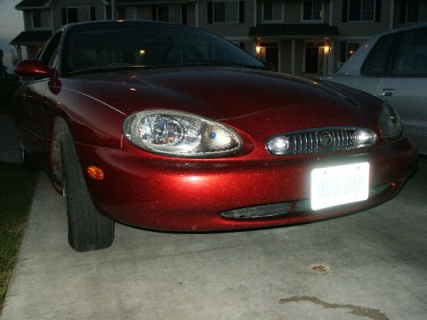 1998 Mercury Sable - Front view of a red 1998 Mercury Sable with a license plate visible.