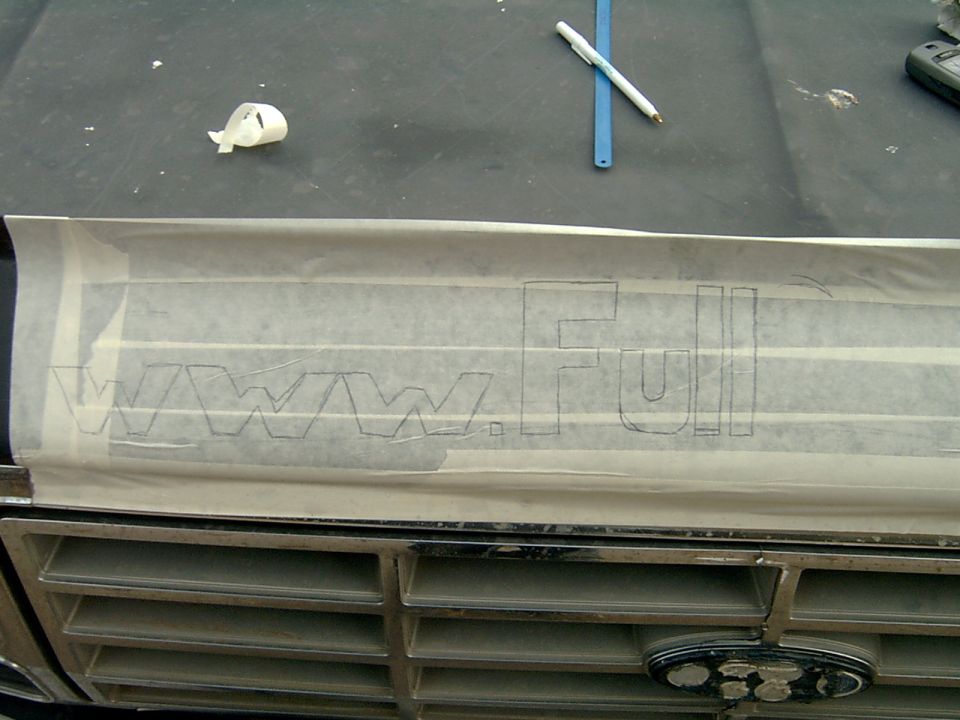 Masking tape on a vehicle grille with 'www.Full' outlined in pencil