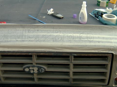 1982 Ford Bronco - The grille of a 1982 Ford Bronco features "Full Size Bronco" lettering taped to the hood above it.
