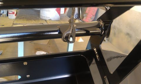 1995 Ford Bronco - Close-up of a black painted metal frame with a hook, possibly part of a trailer hitch or winch system.