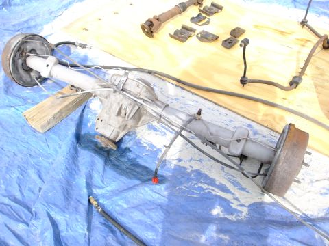 1995 Ford Bronco - Rear axle assembly and associated parts laid out on a blue tarp.