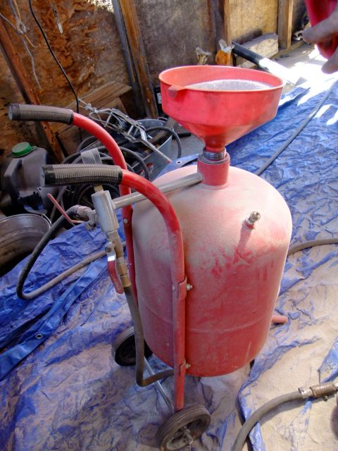 1995 Ford Bronco - This sandblaster has a funnel attachment and is covered in dust.
