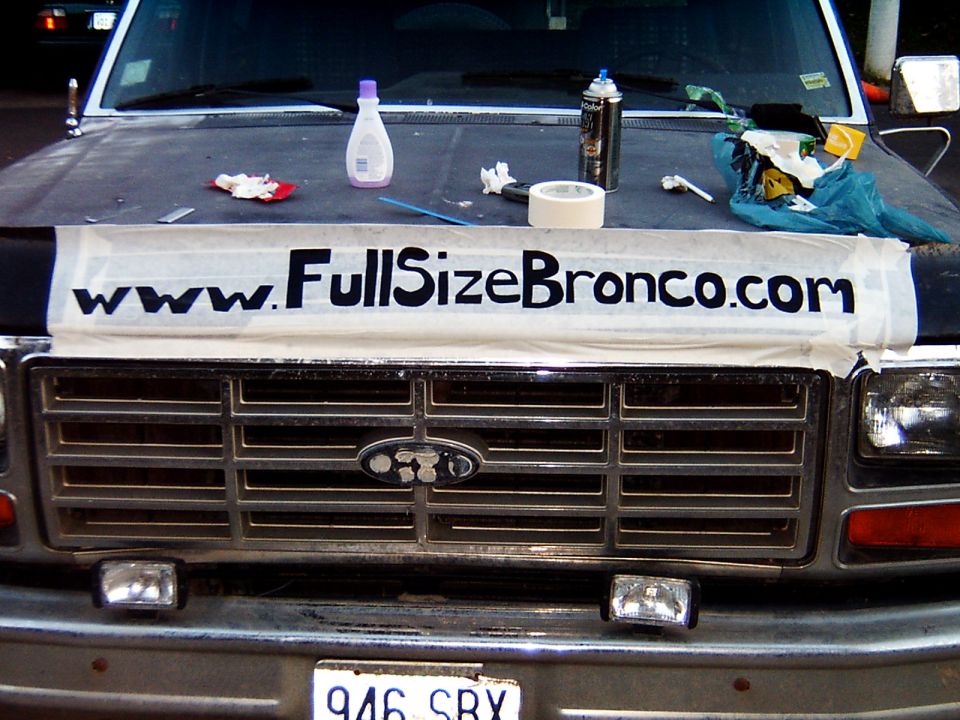 Front view of a Ford Bronco with a www.FullSizeBronco.com banner taped to the hood above the grille