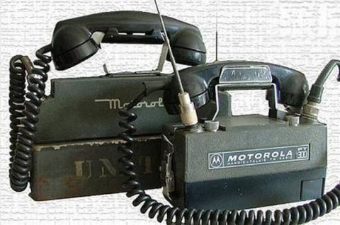 1979 Ford Bronco - Two vintage Motorola handheld FM radios are shown, each with a handset and antenna.