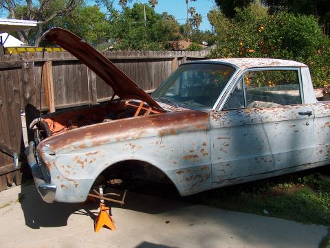 1960 Ford Ranchero - This 1960 Ford Ranchero is in rough condition, with rust and primer visible, and the hood is propped open.