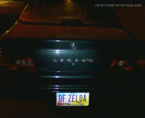 2006 Ford E350 - Rear view of an Acura Legend sedan at night, displaying a custom license plate.