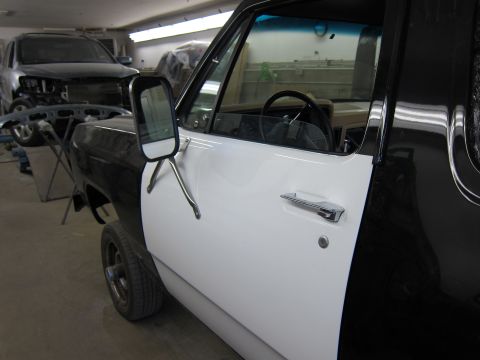 1987 Dodge 1500 - A Dodge pickup truck is undergoing repairs in a workshop, with another vehicle visible in the background.