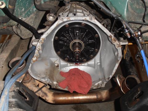 1990 Ford Bronco - Close-up view of a transmission torque converter, with a red rag placed on the lower part of the assembly.