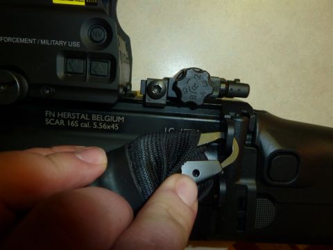 1992 Ford Mustang - Close-up view of the sling attachment mechanism on an FN SCAR 16S rifle.