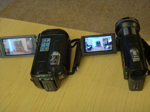 1993 Ford Taurus - Two camcorders are displayed on a wooden surface, with their screens showing interior views.
