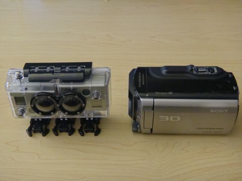 1993 Ford Taurus - A Sony 3D Handycam is shown next to a GoPro Hero 2 camera, both resting on a wooden surface.