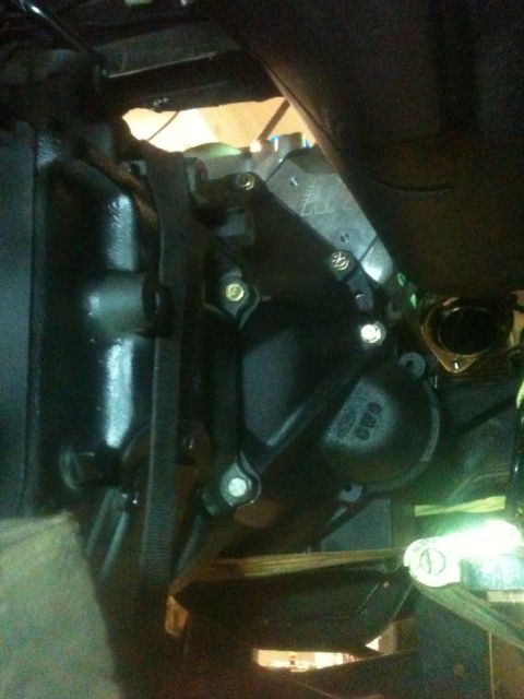 1993 Ford Bronco - Close-up view of a black engine component with visible fasteners and labeling.