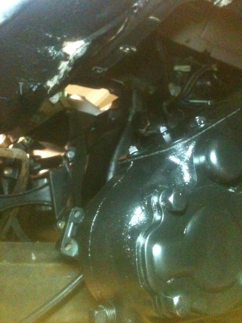 1993 Ford Bronco - Close-up view of the underbody of a vehicle, focusing on the transmission and suspension parts.