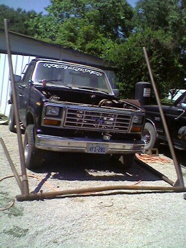 1989 Ford Bronco - This Ford truck, likely from the early 1980s, is parked outdoors with its hood up.