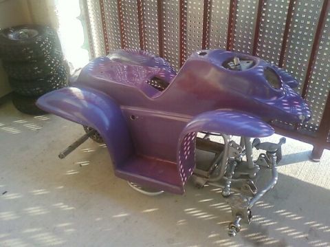 1989 Ford Bronco - The purple body of an ATV is shown, with its frame and wheels partially visible.