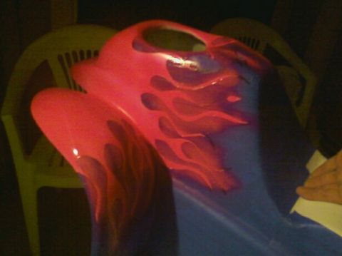 1989 Ford Bronco - A custom painted car part, likely a fender or hood section, features vibrant red flames over a blue base.