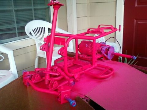 1989 Ford Bronco - A go-kart frame, freshly painted pink, is shown with its engine mounted.