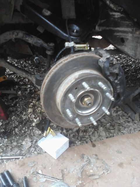 1989 Ford Bronco - The rear brake assembly of a vehicle is shown, with the rotor and caliper clearly visible.