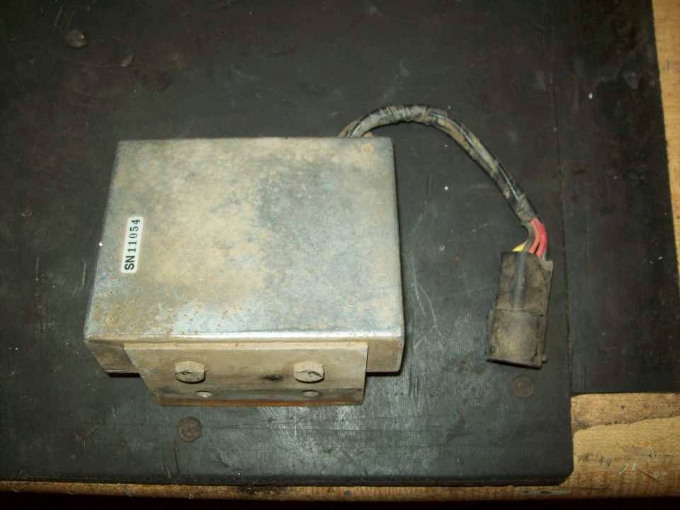 Metal transmission control module with wiring harness and connector. Label reads SN 11054