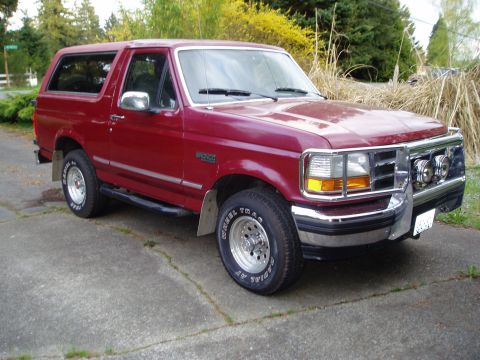 1993 Ford Bronco - This 1993 Ford Bronco is shown in a three-quarter front view, a chrome grille guard and a deep red paint job.